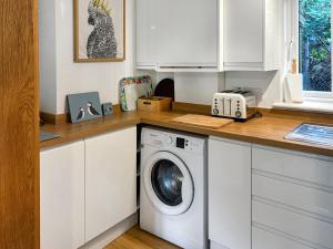 a kitchen with a washing machine on a counter at Bittern Lodge in Cromer