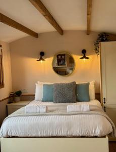a bedroom with a large bed with a mirror at Hafod Shepherd Hut in Aberystwyth +14 photos