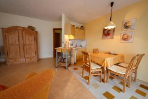 a kitchen and dining room with a table and chairs at Gästehaus Merk Merk Gbr in Immenstaad am Bodensee