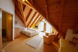a living room with an attic with a bed and chairs at Gästehaus Merk Merk Gbr in Immenstaad am Bodensee