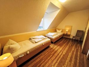 a room with two beds and a window at Ferienhaus Seepark 104 in Hoddersdeich