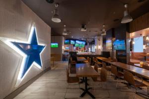 a restaurant with a blue star on the wall at Sandman Signature Newcastle Hotel in Newcastle upon Tyne
