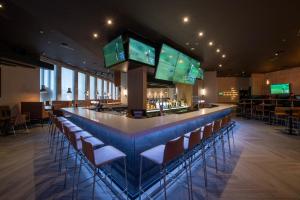 a bar in a restaurant with a bunch of chairs at Sandman Signature Newcastle Hotel in Newcastle upon Tyne +57 photos