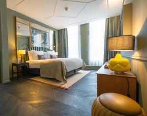 a bedroom with a bed and a large mirror at The Collector in The Hague