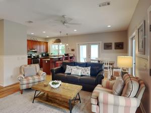 a living room with a couch and chairs and a table at Billfish in Tybee Island