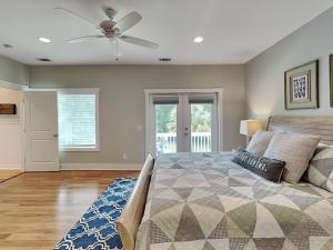 a bedroom with a bed and a ceiling fan at Billfish in Tybee Island