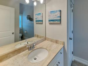 a bathroom with a sink and a mirror at Billfish in Tybee Island +31 photos