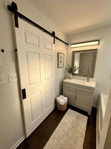 a bathroom with a white door and a sink at Cozy Modern Villa in New Castle