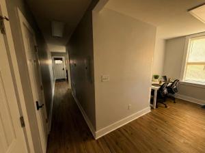 an empty hallway of an apartment with a table and chairs at Cozy unit King bed & laundry in Wilmington