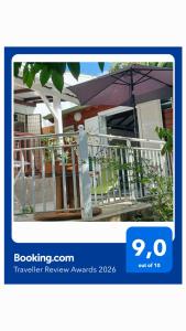 a picture of a house with an umbrella at Gite Mamour - Charmant petit bungalow à découvrir in Baillif