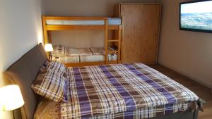 a small bedroom with a bed and a tv at Vila Gabriela in Buşteni