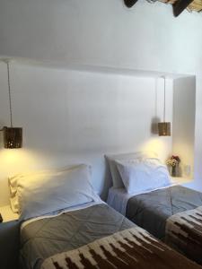 two beds sitting next to each other in a bedroom at Los Arcabuceros Casa Hotel Boutique in Tilcara +202 photos