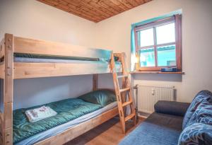 a bedroom with two bunk beds and a window at Ferienwohnung Hauzenberg mit Pool & Sauna in Hauzenberg +45 photos