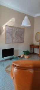 a living room with a couch and a map on the wall at Il nido in Marina di Massa