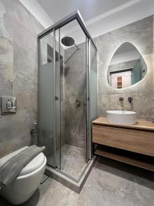 a bathroom with a shower and a toilet and a sink at sun studios in Mikonos +74 photos