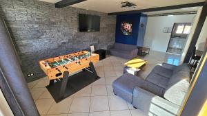 a living room with a lego table and a couch at Blue Duplex Proche Paris & Stade De France in Drancy