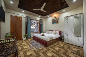 a bedroom with a bed and a window at The Starlight Hotel Kasauli by Splendid Retreat Hotels in Kasauli