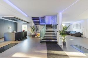 a living room with a staircase in a house at Villa Primodì in Bologna +12 photos