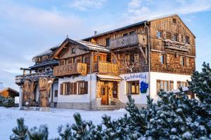 a large wooden house in the snow at Almhaus Dachsteinblick am Feuerkogel in Ebensee