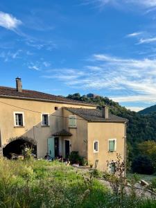 a house with people sitting outside of it at Gîte en Cévennes in Sumène