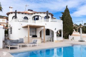 a villa with a swimming pool and a house at Casa SD in Casas de Torrat