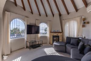 a living room with a couch and a tv at Casa SD in Casas de Torrat