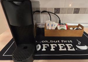 a black box with a coffee sign next to a phone at Apartamentos Monte Hernanz in Riaza