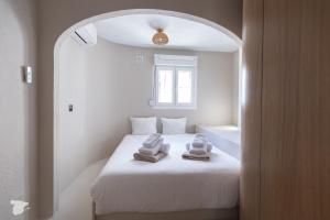 a bedroom with a bed with towels on it at Casa SD in Casas de Torrat +39 photos