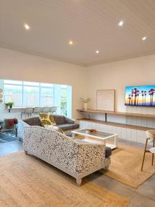 a living room with a couch and a table at Beachouse@Stilbaai in Stilbaai