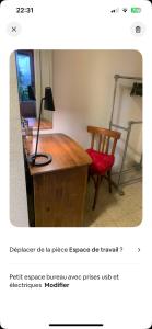 a desk with a lamp and a chair in a room at Lemoine in Châteauroux