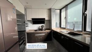 a small kitchen with a sink and a window at Family-friendly apartment in Dongguan