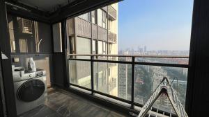 a room with a balcony with a view of a city at Family-friendly apartment in Dongguan