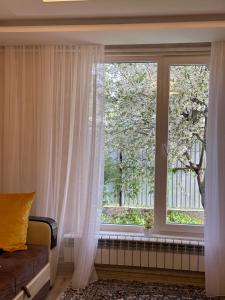 a window with white curtains in a room at Davos in Ak-Bulun