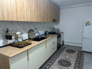 a kitchen with a counter and a sink and a refrigerator at Davos in Ak-Bulun