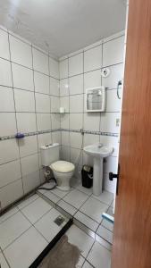 a bathroom with a toilet and a sink at Casa Mirante da Sereia in Salvador +19 photos