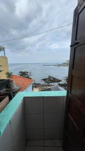 a view of the ocean from the balcony of a house at Casa Mirante da Sereia in Salvador