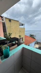 a balcony with a potted plant on top of a building at Casa Mirante da Sereia in Salvador