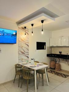 a kitchen with a table and chairs in a room at Pôr do Sol - Serraruna in Araruna