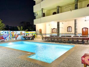 a swimming pool in front of a building at night at Luxor View Hotel in Luxor