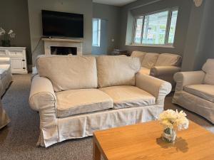 a living room with a couch and a table at Stonehenge Farmhouse in Salisbury
