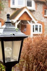 a close up of a street light in front of a house at Stonehenge Farmhouse in Salisbury