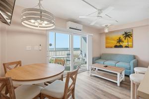 a dining room and living room with a table and a couch at Windward Passage in Fort Myers Beach
