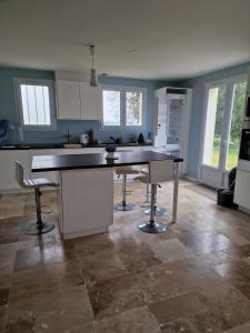 a kitchen with a table and chairs in a room at pavillon en pleine nature in Brains-sur-Gée