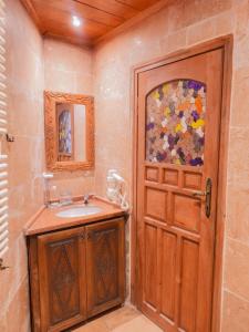 a bathroom with a sink and a wooden door at Kismet Cave House in Göreme +74 photos