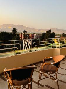 two chairs sitting on top of a balcony at Luxor View Hotel in Luxor