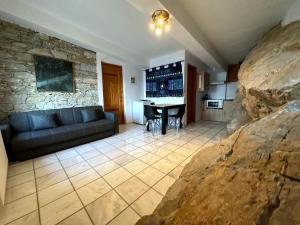 a living room with a couch and a table at Kofinas villa Evdilos by BRP-PROPERTIES in Evdilos
