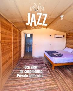 a room with a bed and a sign on the ceiling at Jazz Nuwibaa Camp in Wāsiţ