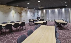 a conference room with wooden tables and chairs at Scandic Luleå in Luleå