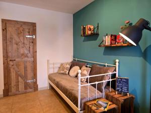 a bedroom with a bed and a blue wall at Casa Cingoli in Cingoli +55 photos