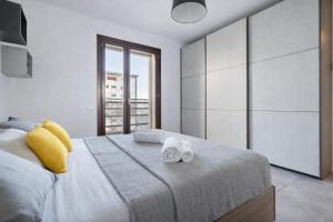 a bedroom with a large bed with two towels on it at Sarca 11th Floor in Milan